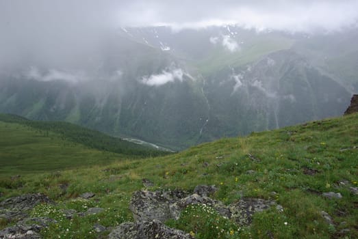 Mountain landscape. Highlands, the mountain peaks, gorges and valleys. The stones on the slopes.