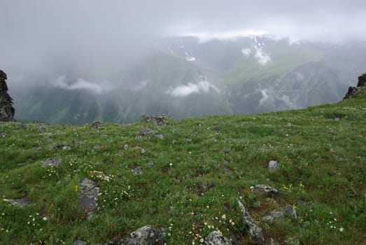 Mountain landscape. Highlands, the mountain peaks, gorges and valleys. The stones on the slopes.