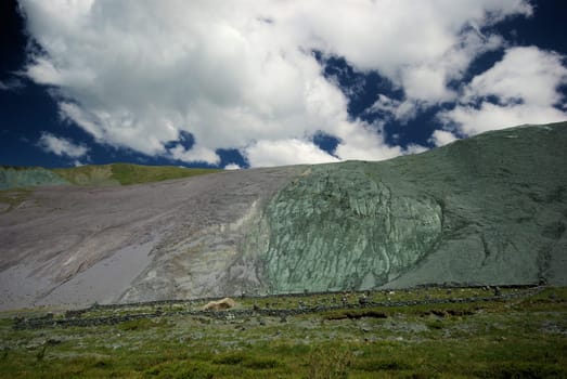 Mountain landscape. Highlands, the mountain peaks, gorges and valleys. The stones on the slopes.