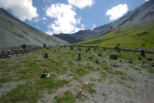 Mountain landscape. Highlands, the mountain peaks, gorges and valleys. The stones on the slopes.