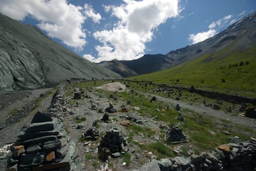 Mountain landscape. Highlands, the mountain peaks, gorges and valleys. The stones on the slopes.