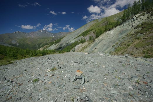 Mountain landscape. Highlands, the mountain peaks, gorges and valleys. The stones on the slopes.