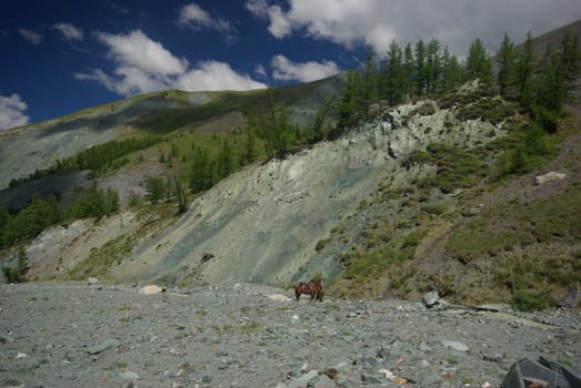 Mountain landscape. Highlands, the mountain peaks, gorges and valleys. The stones on the slopes.