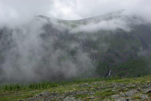Mountain landscape. Highlands, the mountain peaks, gorges and valleys. The stones on the slopes.