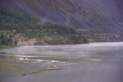 Mountain landscape. Highlands, the mountain peaks, gorges and valleys. The stones on the slopes.