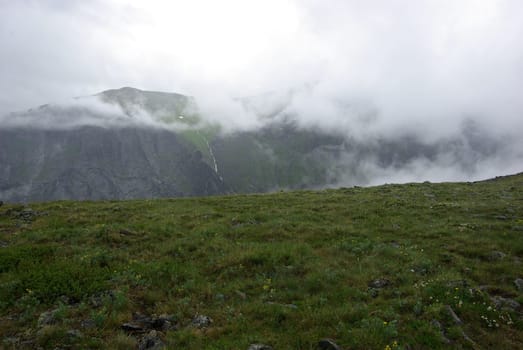 Mountain landscape. Highlands, the mountain peaks, gorges and valleys. The stones on the slopes.