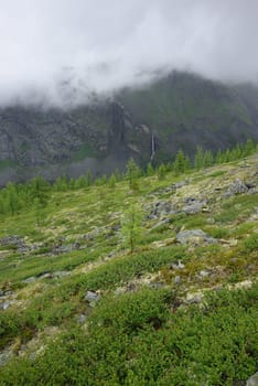 Mountain landscape. Highlands, the mountain peaks, gorges and valleys. The stones on the slopes.