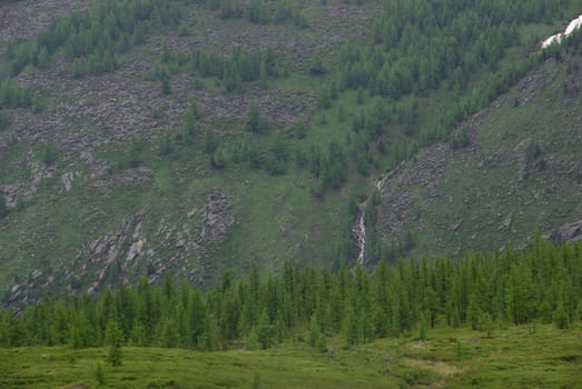 Mountain landscape. Highlands, the mountain peaks, gorges and valleys. The stones on the slopes.
