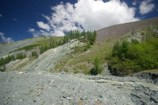Mountain landscape. Highlands, the mountain peaks, gorges and valleys. The stones on the slopes.