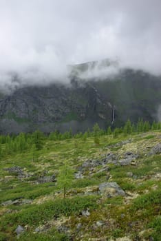 Mountain landscape. Highlands, the mountain peaks, gorges and valleys. The stones on the slopes.
