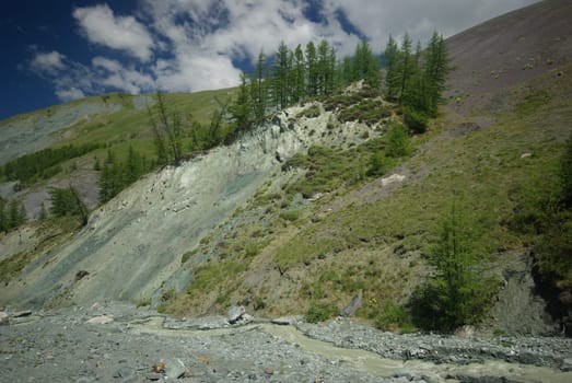 Mountain landscape. Highlands, the mountain peaks, gorges and valleys. The stones on the slopes.