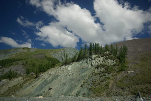 Mountain landscape. Highlands, the mountain peaks, gorges and valleys. The stones on the slopes.