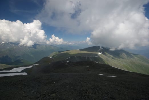 Mountain landscape. Highlands, the mountain peaks, gorges and valleys. The stones on the slopes.