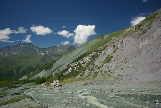 Mountain landscape. Highlands, the mountain peaks, gorges and valleys. The stones on the slopes.