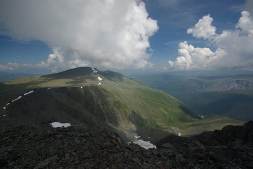 Mountain landscape. Highlands, the mountain peaks, gorges and valleys. The stones on the slopes.