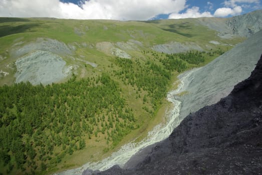 Mountain landscape. Highlands, the mountain peaks, gorges and valleys. The stones on the slopes.