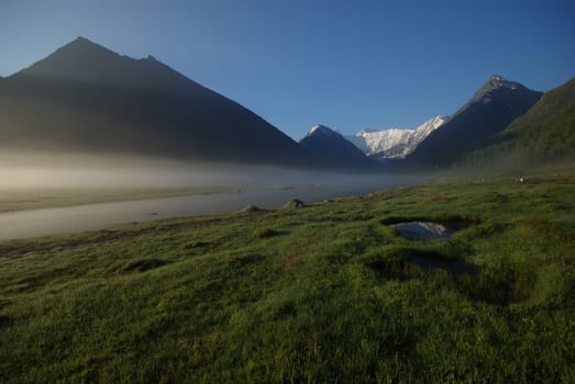 Mountain landscape. Highlands, the mountain peaks, gorges and valleys. The stones on the slopes.