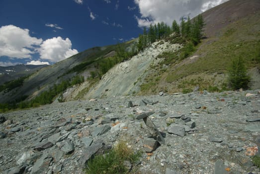 Mountain landscape. Highlands, the mountain peaks, gorges and valleys. The stones on the slopes.
