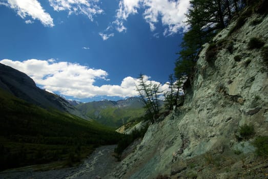 Mountain landscape. Highlands, the mountain peaks, gorges and valleys. The stones on the slopes.