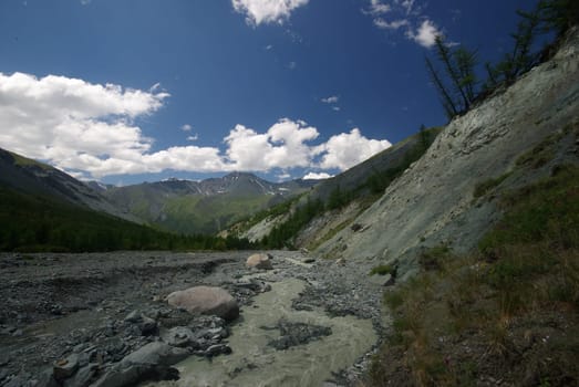 Mountain landscape. Highlands, the mountain peaks, gorges and valleys. The stones on the slopes.
