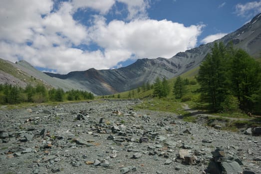 Mountain landscape. Highlands, the mountain peaks, gorges and valleys. The stones on the slopes.