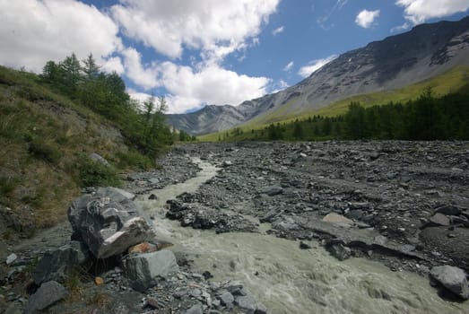 Mountain landscape. Highlands, the mountain peaks, gorges and valleys. The stones on the slopes.