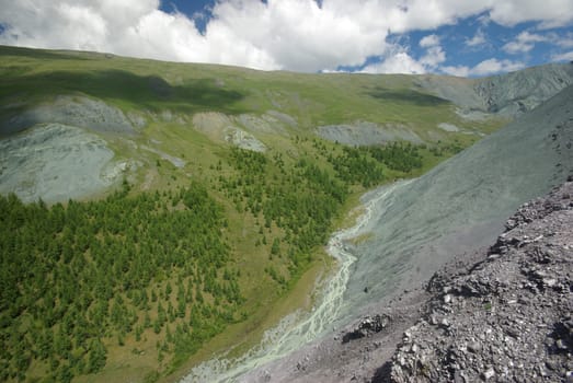 Mountain landscape. Highlands, the mountain peaks, gorges and valleys. The stones on the slopes.