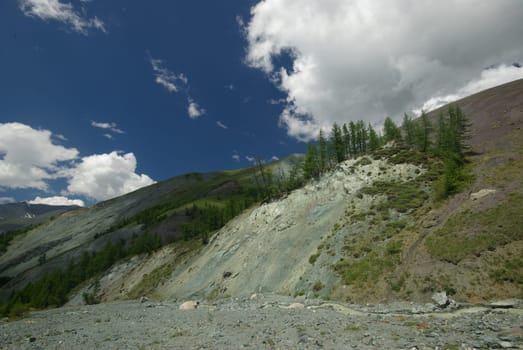 Mountain landscape. Highlands, the mountain peaks, gorges and valleys. The stones on the slopes.