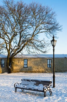 Bench and street lamp in the park winter Old Tallinn