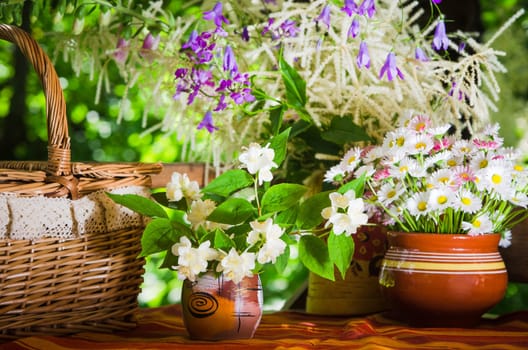 Buns in a wicker basket and a bouquet of flowers
