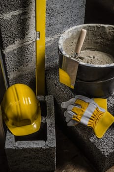 Tools for bricklayer bucket with a solution and a trowel, close-up