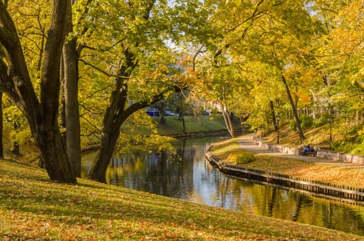 Beautiful autumn park at the channel in Riga