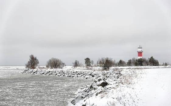 Light House with Icy Ocean and a cloudy sky.