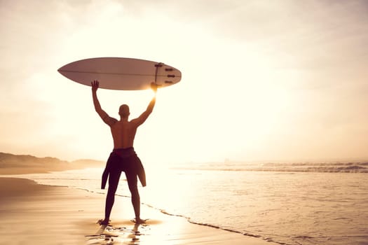A surfer with his surfboard at the beach