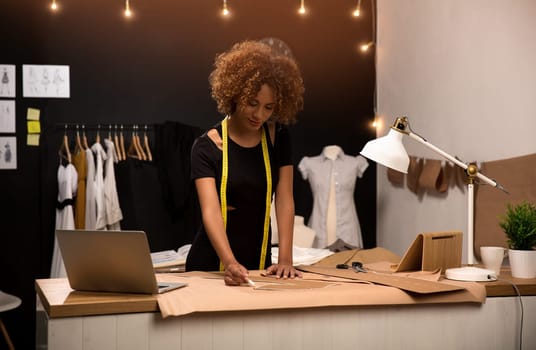 A young fashion designer working on her atelier