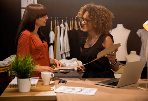 Two young entrepreneur women, and fashion designer working on her atelier