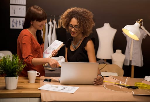 Two young entrepreneur women, and fashion designer working on her atelier