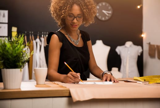 A young fashion designer working on her atelier