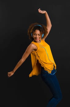 Beautiful African American woman listen music and dancing