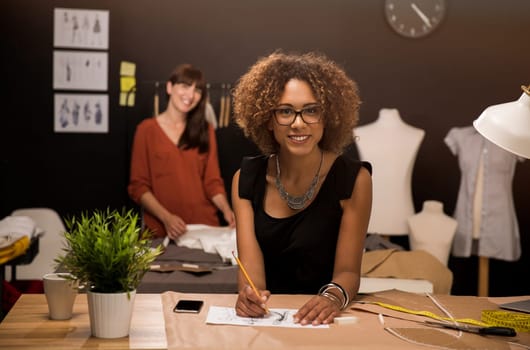 Two young entrepreneur women, and fashion designer working on her atelier