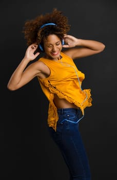 Beautiful African American woman listen music and dancing
