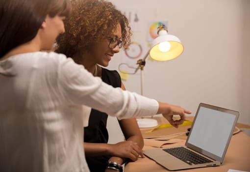Two young entrepreneur women, and fashion designer working on her atelier
