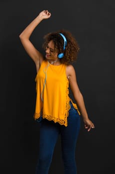 Beautiful African American woman listen music and dancing