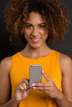 Beautiful African American woman making a phone call and laughing