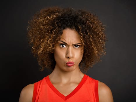 Portrait of a beautiful African American woman with a suspicious expression