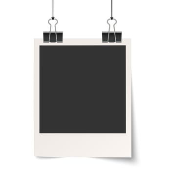old empty photo with binder clips hanging at black twine