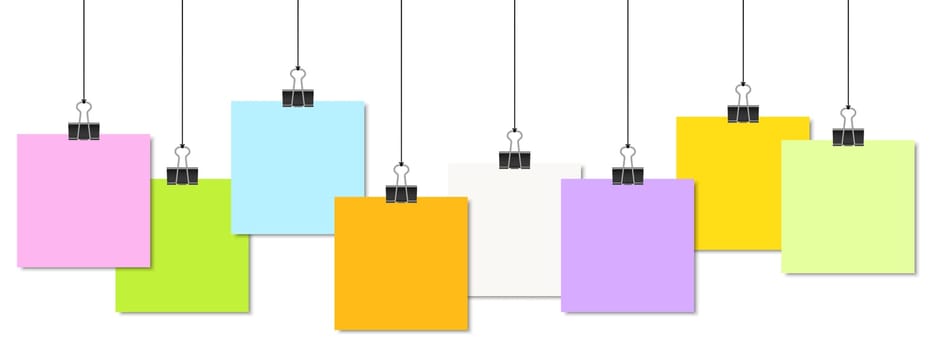 empty colored papers with binder clips hanging at black twine