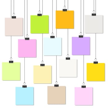 empty colored papers with binder clips hanging at black twine