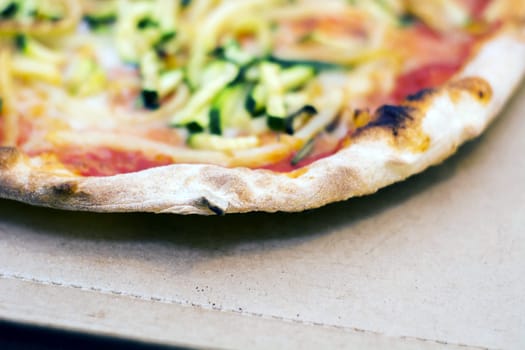 Close up of a tasty pizza with zucchini and potatoes