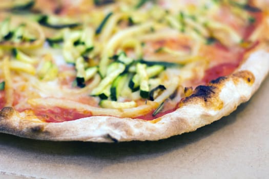Close up of a tasty pizza with zucchini and potatoes